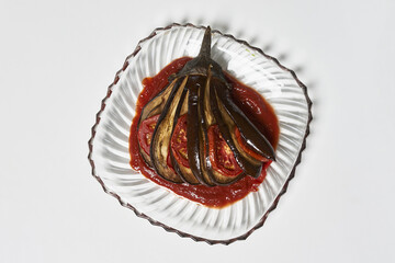 Poster - Overhead shot of delicious eggplant with tomato sauce isolated on white background