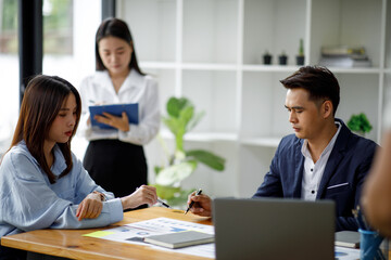 Presentation. Young confident successful business Asian people discuss and analyze work, statistics, plans, presentations, startups in a meeting room. Teamwork. 