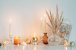 christmas decorations with burning candles in white room