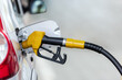 © lucky pics - Silver car refuelling at the gas station, the concept of fuel energy