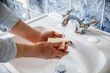 © Image Source RF - UK, London, Close-up of man washing hands in bathroom