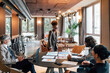 © Image Source RF - Italy, Business people having meeting in creative studio