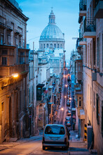 Malta, Valletta, Old Town Narrow Street With Basilica Dome In Background