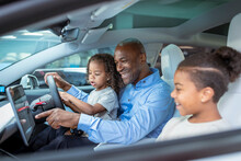 UK, Father With Daughter And Son Sitting In Car