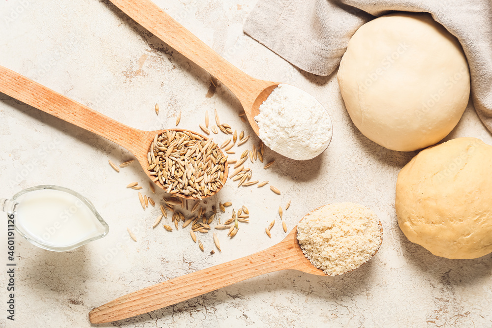 Fresh raw dough and ingredients on grunge background