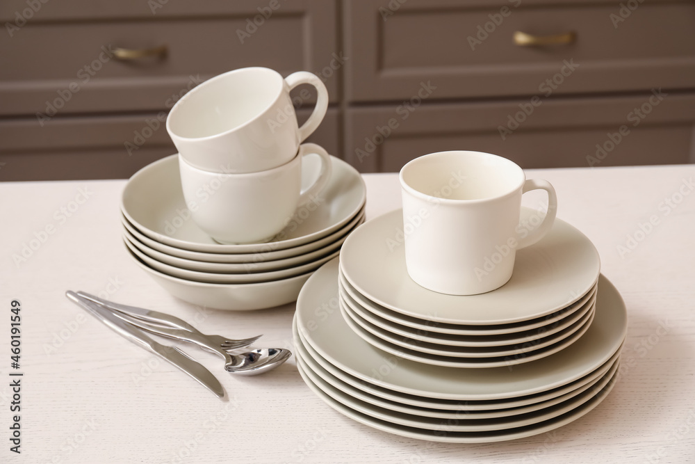 Set of clean dishes on table in kitchen Stock Photo | Adobe Stock