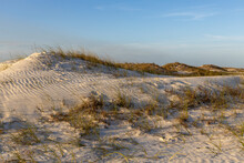 Natural Sand Dunes With Grass And Blue Skies