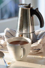 Wall Mural - Vertical shot of a cup of coffee under sunligh