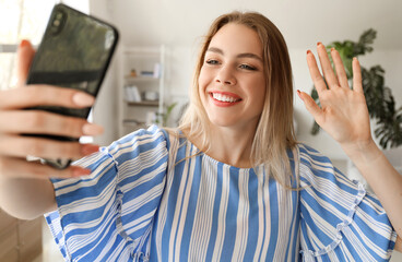 Sticker - Young woman taking selfie at home