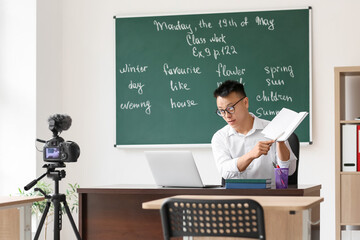 Canvas Print - Asian teacher conducting English lesson online