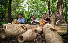 Asian Elderly Man And Woman Gathered Together To Weave From Bamboo By Hand. Handicrafts Of Local Elderly People, Thailand