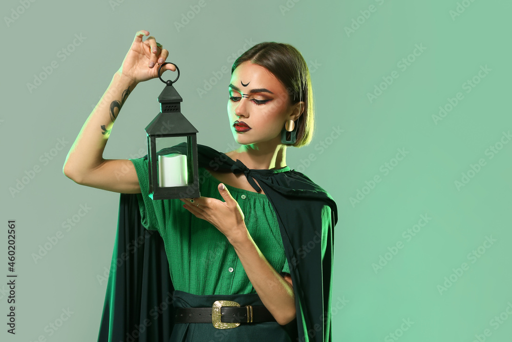 Beautiful woman dressed as witch for Halloween on color background