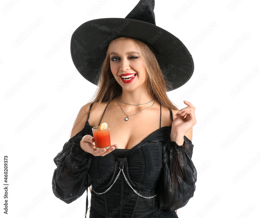 Sexy young witch with cocktail on white background