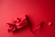 Red Gift Box On Red Background For Christmas Or Valentine's Day.
