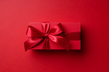 Top View On Red Gift Box On Red Background For Christmas Or Valentine's Day.