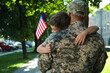 © New Africa - Soldier and his little son with flag of USA hugging outdoors