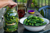 Fototapeta  - hand-made pickled cucumbers in a jar. Ręcznie robione ogórki kiszone w słoiku.