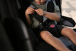© New Africa - Little boy fastened with car safety belt in child seat, closeup