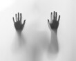 © chalyshevae - Halloween scary picture of hand silhouette behind the frosted glass