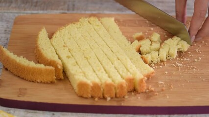 Wall Mural - Women pastry chef cuts biscuit dough into small pieces.