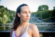 © luisrojasstock - portrait caucasian young athlete woman posing without looking at camera with train tracks in the background