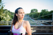 © luisrojasstock - portrait caucasian young athlete woman posing without looking at camera with train tracks in the background