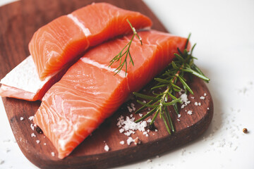 Wall Mural - Fresh salmon fish, Raw salmon filet with lemon rosemary herbs and spices