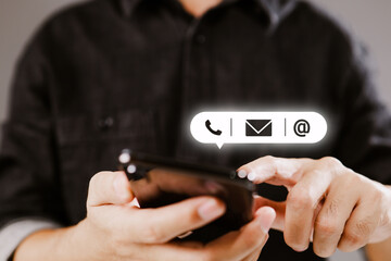 Poster - CONTACT US. Customer support concept, copy space. Hand of Businessman holding mobile smartphone with ( mail,phone,email ) icon.