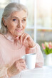 © aletia2011 - Portrait of beautiful smiling senior woman drinking tea