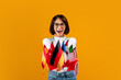 Foreign language studying school concept. Excited lady showing bunch of diverse flags, posing over yellow background