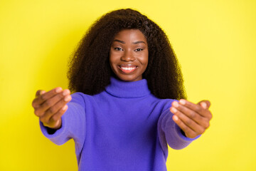 Poster - Portrait of pretty positive dark skin lady raise hands to camera invite to hug isolated on yellow color background