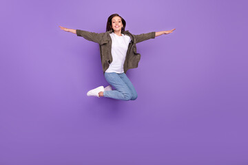 Poster - Full length body size photo smiling woman jumping up cheerful careless isolated pastel violet color background