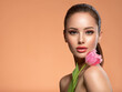 © Valua Vitaly - Beautiful white girl with flower. Stunning girl with  pink tulip. Closeup face of young woman with a healthy clean skin.
