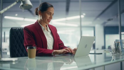 Poster - Successful Caucasian Businesswoman in Perfectly Stylish Suit Working on Laptop Computer on Top Floor Office Overlooking Big City. Female CEO Managing Environmental, Social and Corporate Governance
