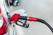 © lucky pics - Silver car refuelling at the gas station, the concept of fuel energy