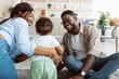 © Prostock-studio - Portrait of happy black family smiling playing at home