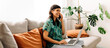 © (JLco) Julia Amaral - Female freelancer working from her couch