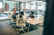 © Jacob Lund - Smiling businesspeople having a virtual meeting with their associates