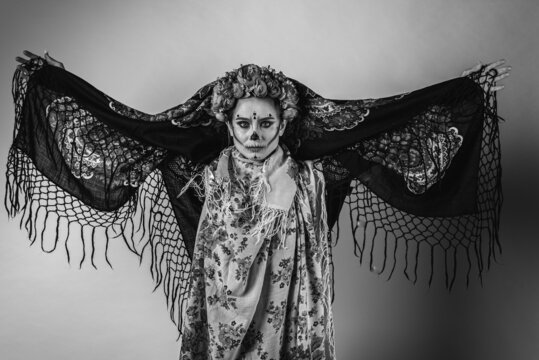black and white emotional portrait, Calavera Katrina demonstrates various emotional gestures to the body, face, in a headscarf, looks and from the side, a place for an inscription. Dia-de -los -muerto