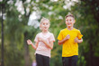 Kids run. Healthy sport. Child sport, heterosexual twins running on track, fitness. Joint training. Running training outdoor brother and sister pre-teen. Jogging with friend. Children athletes