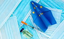 phone with green pass qr code, vaccine ampoule and syringe, face mask,, paper plane in EU european union flag - concept new rules for tourism and travel between european countries
