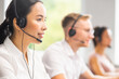 © Acronym - Diverse team of young professionals is working in the phone support office. Working day of sales managers in the call center. Business, telephone consulting and problem solving.