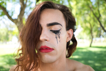 young latina and transsexual woman dressed in fine black lingerie. The woman is posing for the camera with her mascara smudged from crying because of discrimination. Concept diversity, transgender.