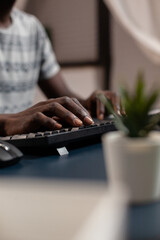 Poster - Closeup of african american young businessman hand typing communication project browsing education information on internet using computer. Entrepreneur working remote from home