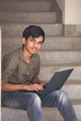 Wall Mural - Indian boy using a laptop while attending the online classes at home	
