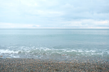 Wall Mural - black sea coast. small waves on the shores of the black sea covered with pebbles