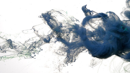 Gray-blue watercolor ink in water on a white background. Gray-blue cloud of ink on a white background. Abstract background. Drops of dark blue ink in water.