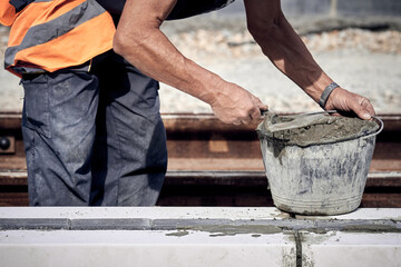 Poster - Construction worker working on a public site reconstruction.