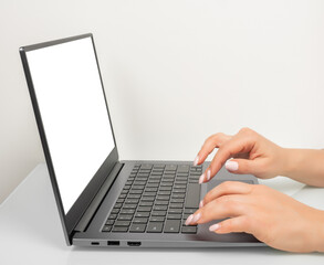 Poster - Business woman hands using mockup laptop with white blank screen. side view. blank screen laptop computer template.Notebook screen for application user interface presentation mock up