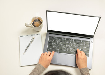 Poster - Laptop with blank screen, hands and accessories on white. Home office workspace mockup. Laptop with blank screen, hands and accessories on white. top view